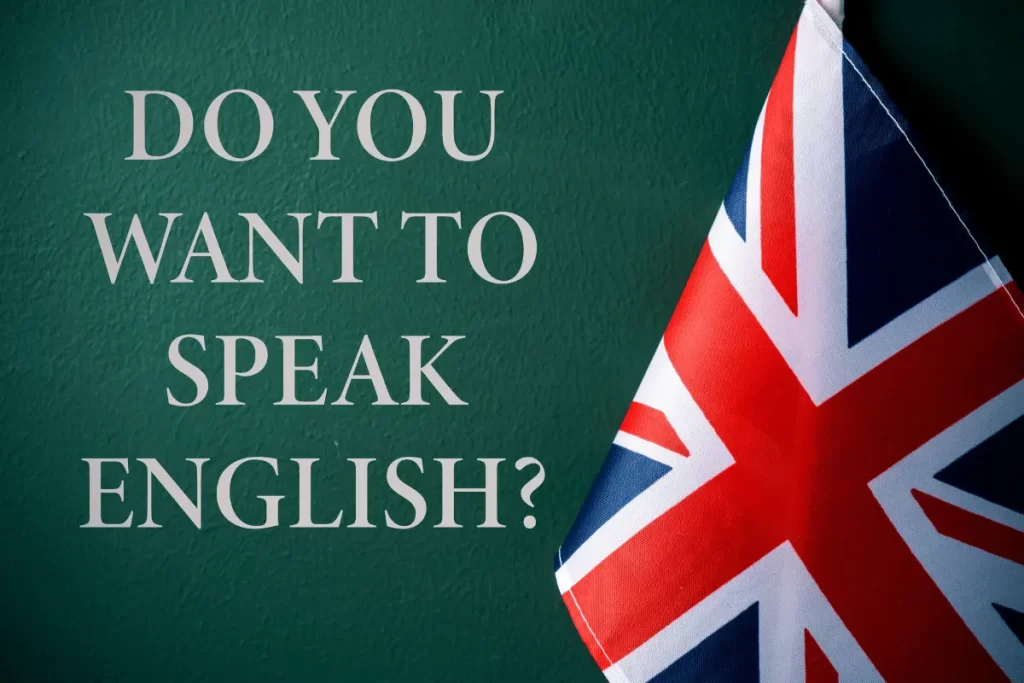 La scritta "Do you want to speak english" su una lavagna con vicino la bandiera inglese